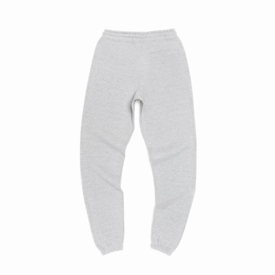 A pair of white sweatpants on top of a white surface.